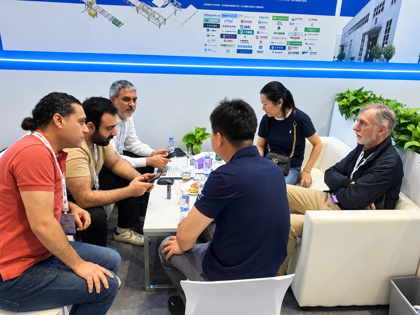 ZRK Group colleagues in discussion with partners around a table at a trade fair