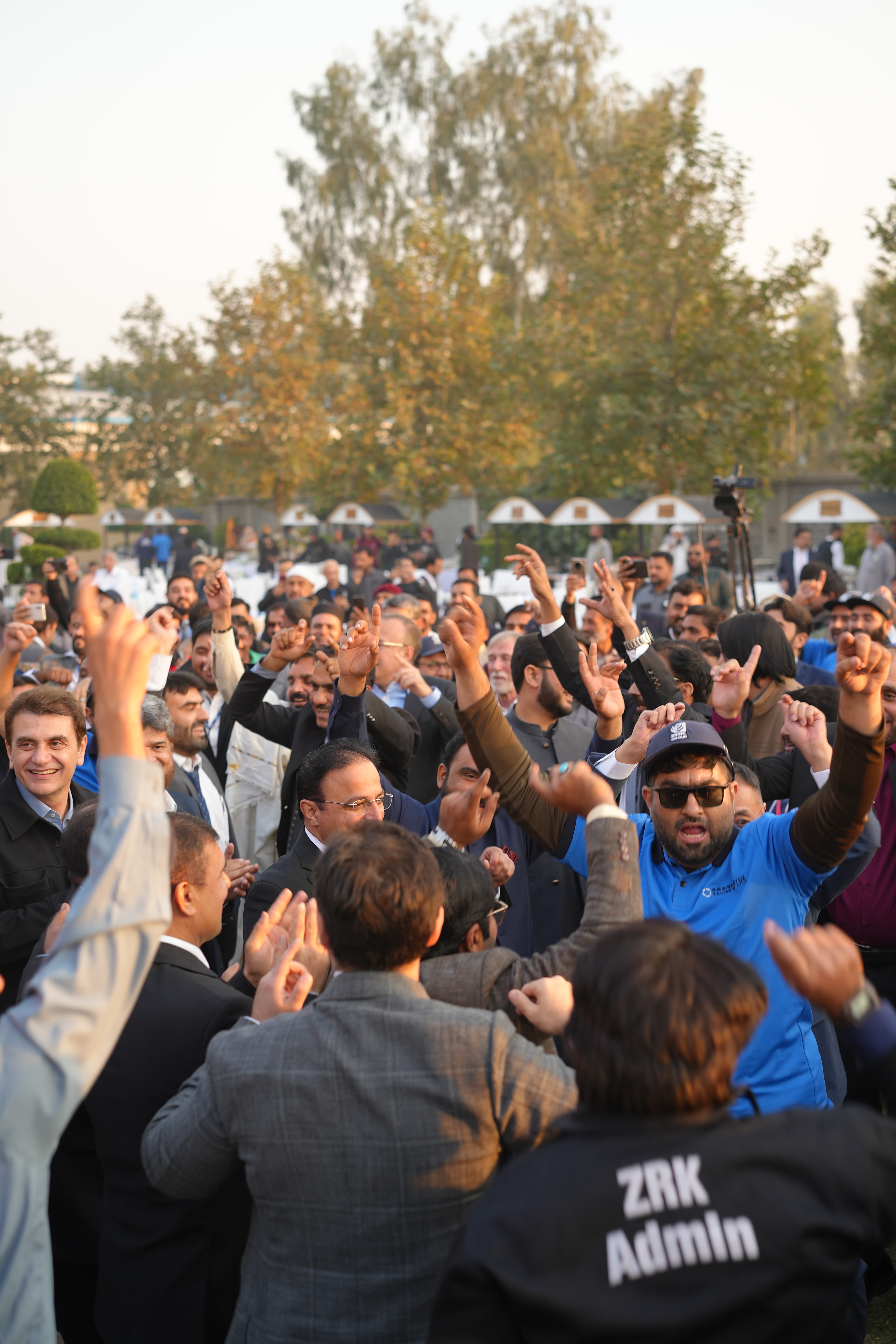 ZRK Group colleagues cheering together at an outdoor company gathering